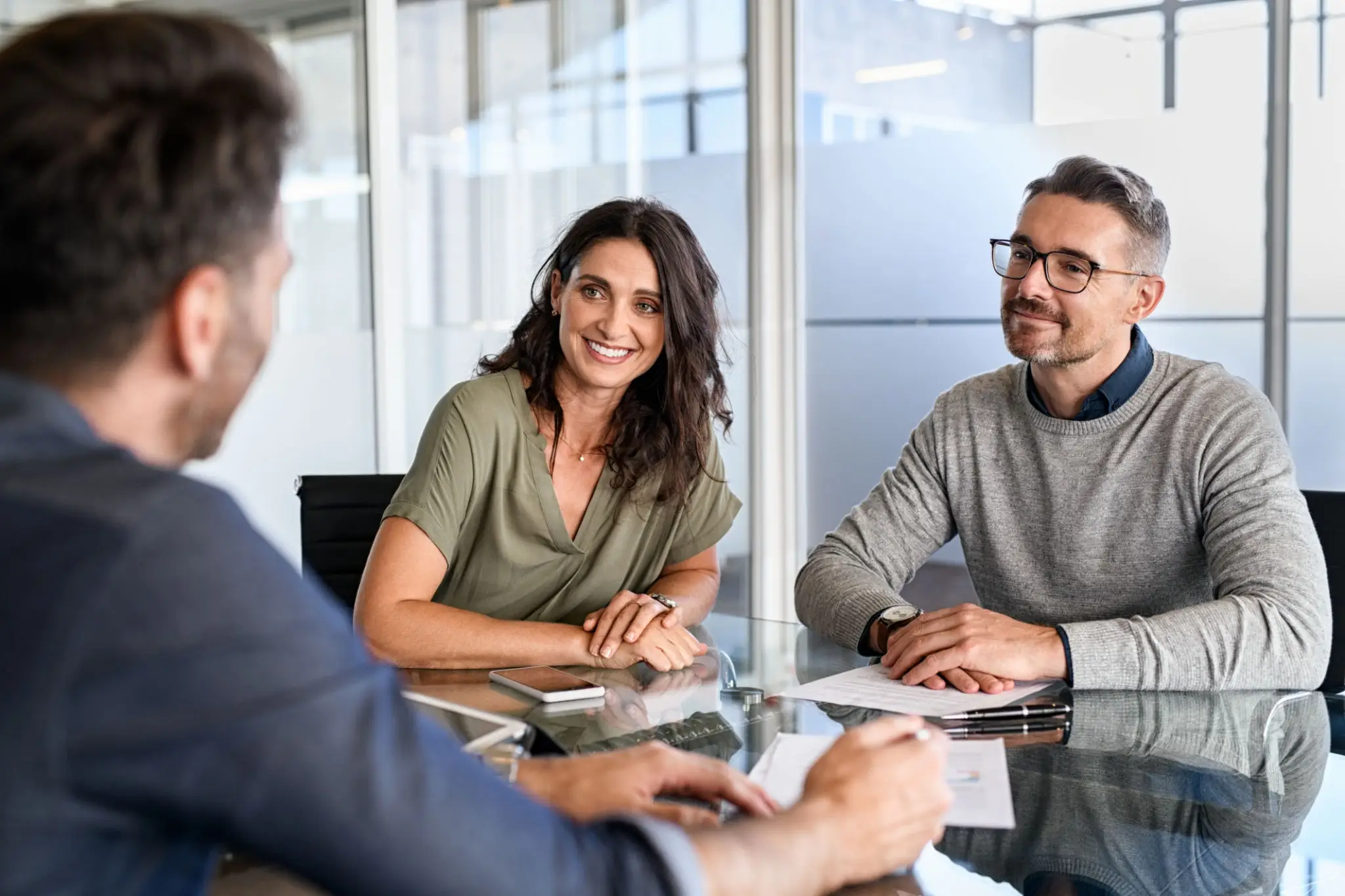 Three colleagues having a positive meeting in a modern office.